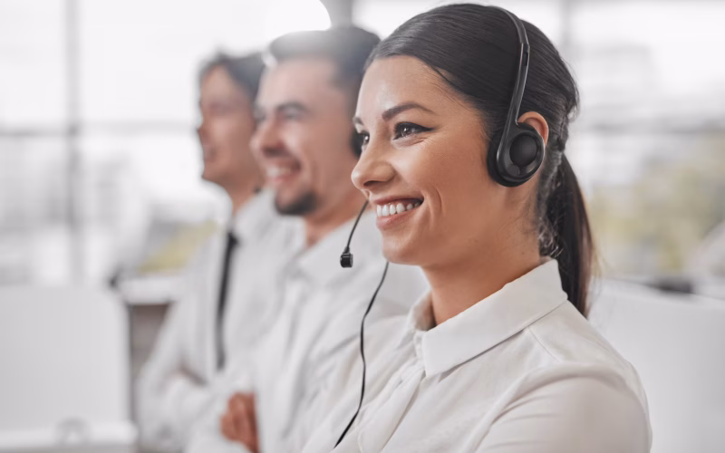 cheerful-call-center-worker-near-colleagues-2025-03-15-00-40-12-utc