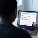 New remote employee reviewing an onboarding checklist on his laptop during his first week