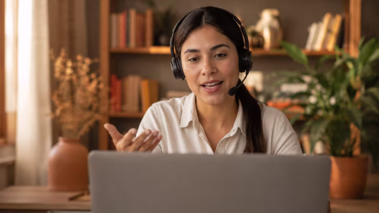 Young Latina professional wearing a headset during a video call job interview